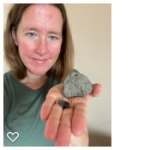 A picture of me holding my and out with a rock on the palm of my hand. 